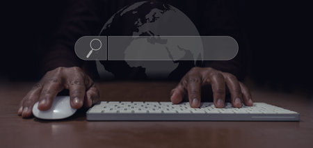 man's hand using mouse and keyboard to search for information, Searching for information in the big...