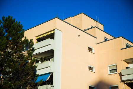 Multi-family house in Munich, yellow facade, blue sky