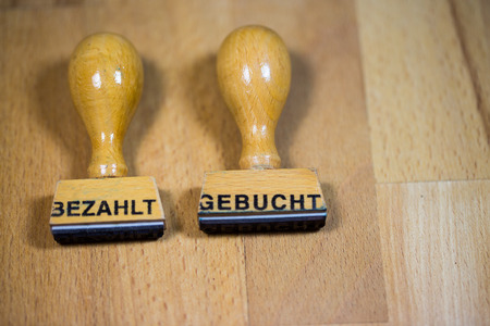 Paid and booked stamps on a piece of paperの写真素材