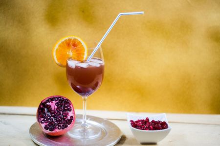 Pomegranate spray (pomegranate spritz ) on golden  backgroundの写真素材
