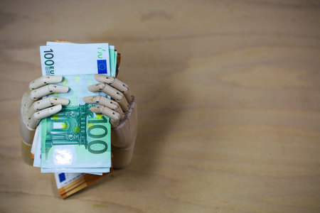 banknotes with hand, woodhand, wooden backgroundの写真素材