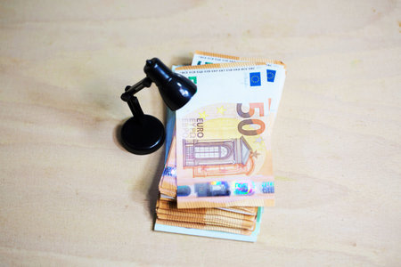Banknotes, euro under the reading lampの写真素材