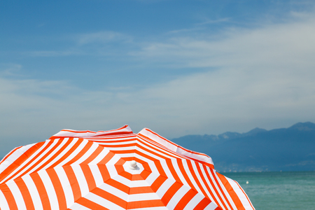 red white parasol on Lake Gardaの写真素材