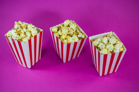 Popcorn in mug on pink backgroundの写真素材