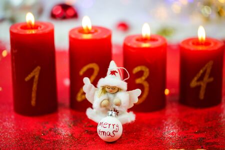 Angel in front of burning candles, decoration, Christmas decorationsの写真素材
