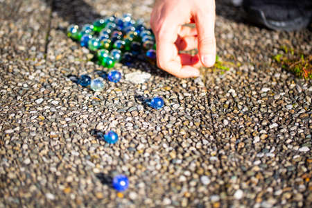 Playing marbles, old children's game, colorful ballsの写真素材