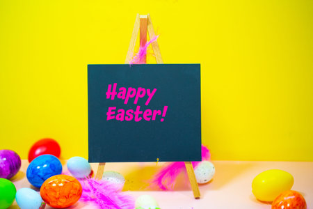 Chalk board with Easter eggs, yellow background