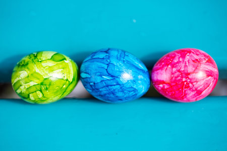 3 easter eggs on aquamarine background, happy, colorful easter,