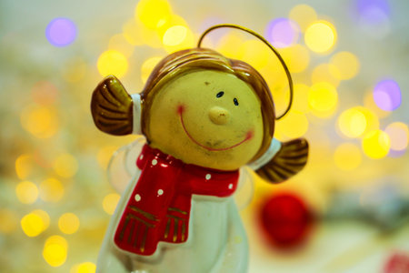 cute angel with Christmas lights as a postcard