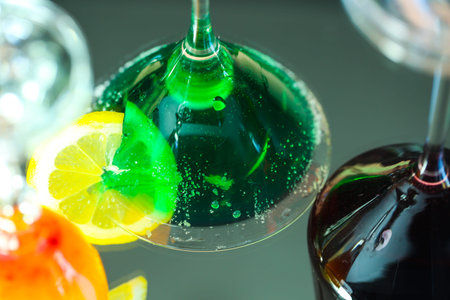 Cocktail with lime and ice on a black background close up