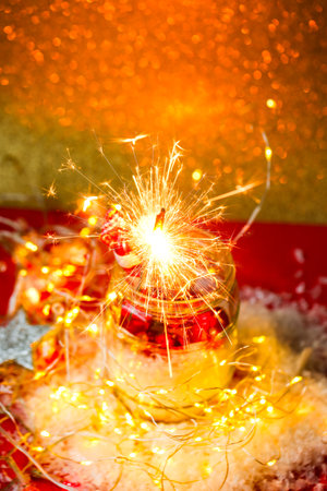 Sparklers in glass on red background, postcardの写真素材