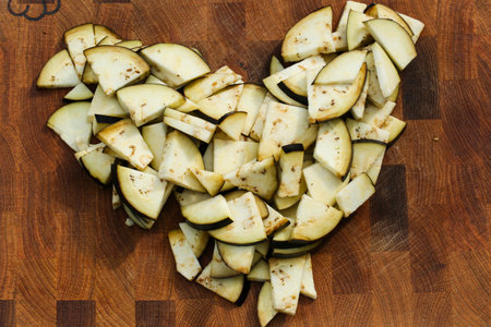 sliced eggplant in heart shape on wooden backgroundの写真素材