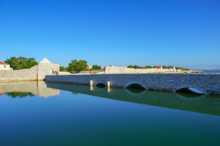 Bridge and old defensive walls of medieval town Nin in Dalmatia, Croatiaの写真素材