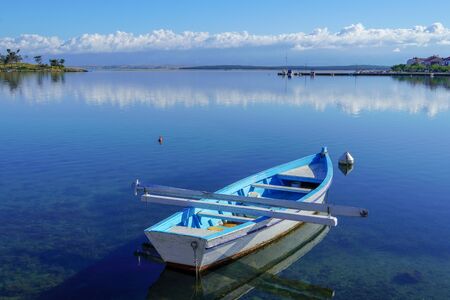 Blue fishing boat and sunrise on the Adriatic Seaの写真素材