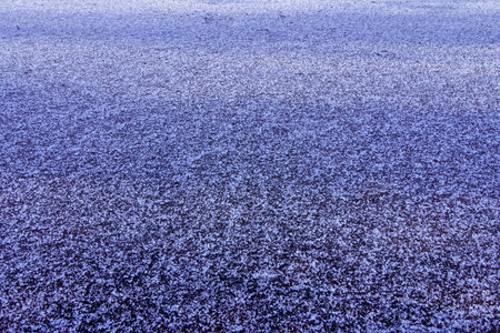 Frozen ice cold deep lake surface with snow