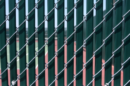 Wind Screen and Fence of a Tennis Court for Sports Backgroundの写真素材