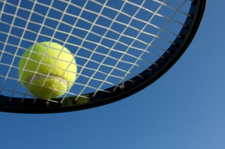 Tennis Ball on a Racket underneath viewの写真素材