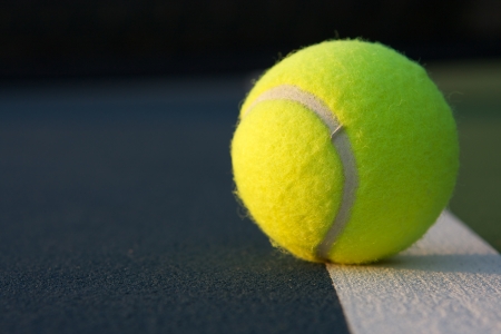 Tennis Ball on a Blue Court Close upの写真素材