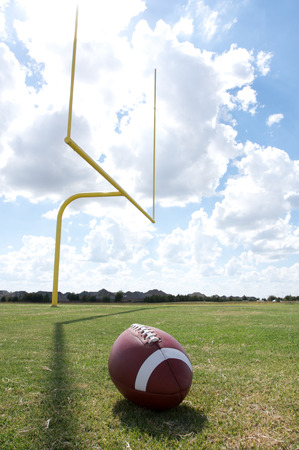 American Football with the goal posts or uprights in the backgroundの写真素材