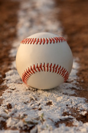 Baseball on the chalk line of the infieldの写真素材