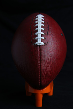 Professional Football Teed Up against Black wall with room for copyの写真素材