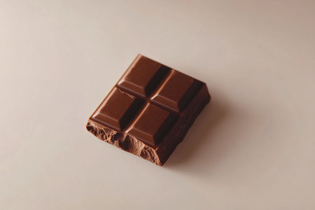 Minimalist Milk Chocolate Bar with Crumbs on a Soft Gradient White Backdropの写真素材