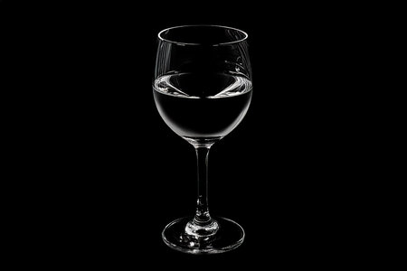 Crystal Clear Water Glass on a Soft Black Backgroundの写真素材