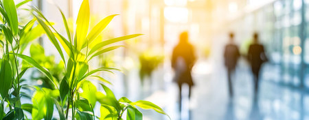 Blurred Motion of Business People in a Modern Office with Greenery and Sunlightの写真素材