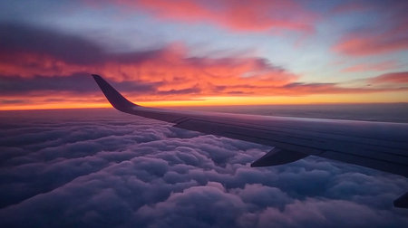 Stunning Sunset from Plane Window with Wing and Cloudscapeの写真素材
