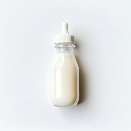 Bottle of baby milk on white background. Flat lay, top view.の写真素材