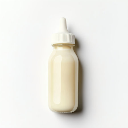 Bottle of baby milk on white background, top view. Flat layの写真素材