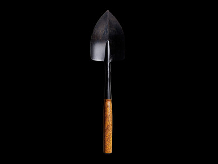 Shovel with wooden handle isolated on black background. Gardening tool