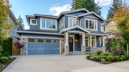 Real showing blue two story house with stone pillars and garage door keywords: house, home, residential, architecture, exterior, blue, siding, stone, pillars, garage door, windows, landscaping, trees, sky, daytime, suburban, real estate, property, dwelling, facade, entrance, roof, daylight, modern, contemporary, neighborhood, construction, house design, outdoor lighting, concrete driveway description: a two-story blue house with a modern aesthetic, featuring stone-clad pillars supporting a...の写真素材