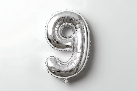 A shiny silver foil balloon in the shape of the numeral 9 is displayed centrally on a plain white...