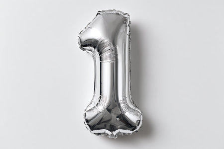 A single, shiny silver foil balloon shaped like the numeral '1' is presented against a clean white...