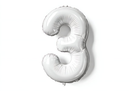 A single, inflated, silver foil balloon shaped like the number 3 is presented against a clean white...