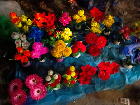 colorful artificial flowers in a shop window, closeup of photoの写真素材