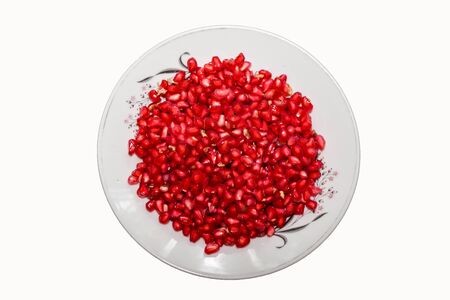 Ripe pomegranate fruit segment isolated on white background cutout. Close-up image of pomegranate seedsの写真素材