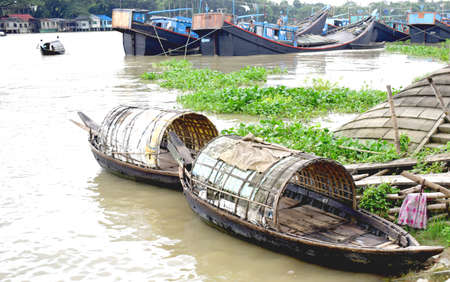 River Side Local People Lifestyle,River View, Traditional Small Boat with cloudy sky .The photo was taken from Shitolokkha River, Narayanganj,Rupgonj on 24th september 2020.のeditorial素材