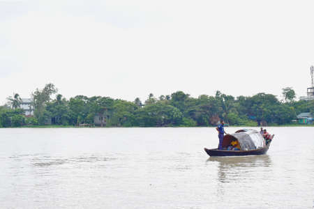 River Side Local People Lifestyle,River View, Traditional Small Boat with cloudy sky .The photo was taken from Shitolokkha River, Narayanganj,Rupgonj on 24th september 2020.のeditorial素材
