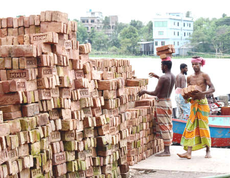 Construction laborer stocking brick near river side,The photo was taken from Shitolokkha River, Narayanganj,Rupgonj on 25th september 2020.のeditorial素材