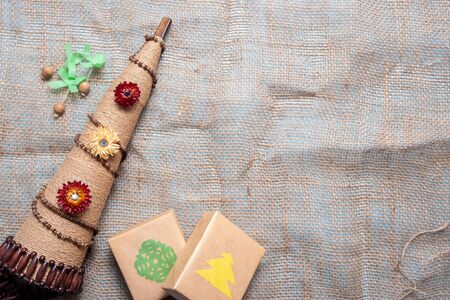 eco-friendly gifts and alternative Christmas tree of twine on the background of burlap large weave. The concept of respect for nature.の写真素材