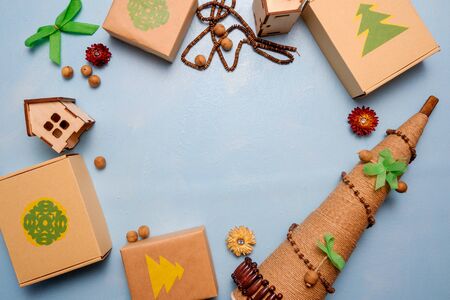 eco-friendly gifts and alternative Christmas tree made of twine on a blue background. The concept of cherish nature.の写真素材