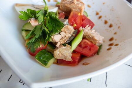 tuna, tomato and cucumber salad dressed with soy sauce. Shallow depth of field.の写真素材