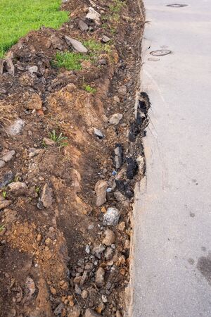 Dug a trench on the sidewalk for pedestrians. Horizontal photo format.の写真素材