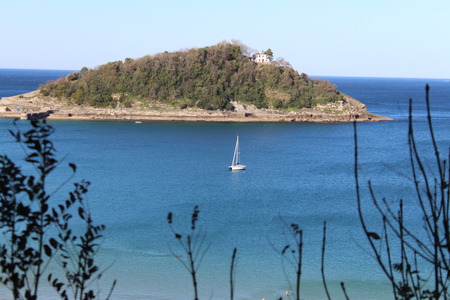 Beautiful view of sea ,boat and island from inside the treesの写真素材
