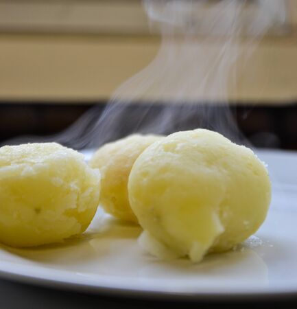 Steamy boiled potatoesの写真素材