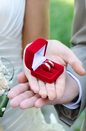Wedding rings in hands at a newly-married coupleの写真素材