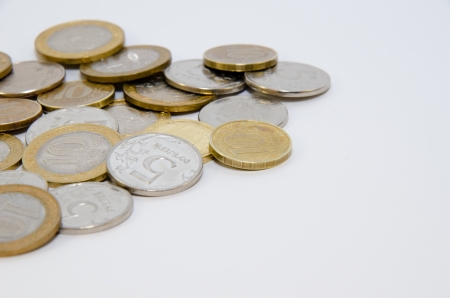 Heap of coins isolated on white backgroundの写真素材