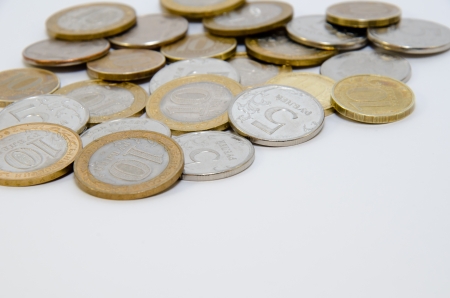 Heap of coins isolated on white backgroundの写真素材